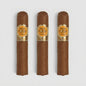 Three brown cigars with gold and orange labels reading 'QUAI D'OR SAY HABANA' arranged vertically on a light gray background.