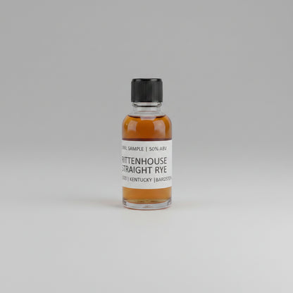 Small bottle of Rittenhouse Straight Rye on a light pink background