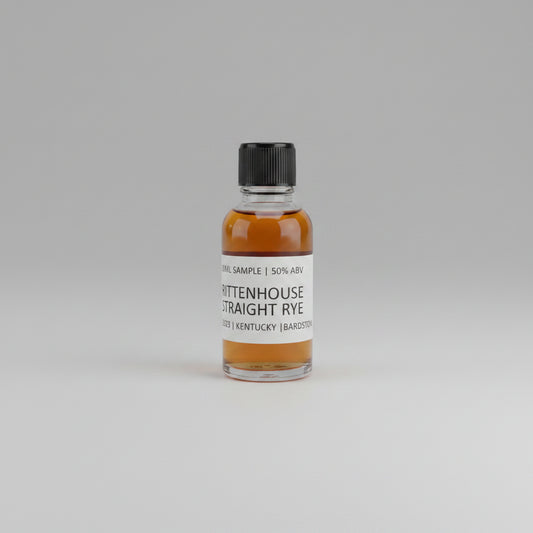 Small bottle of Rittenhouse Straight Rye on a light pink background