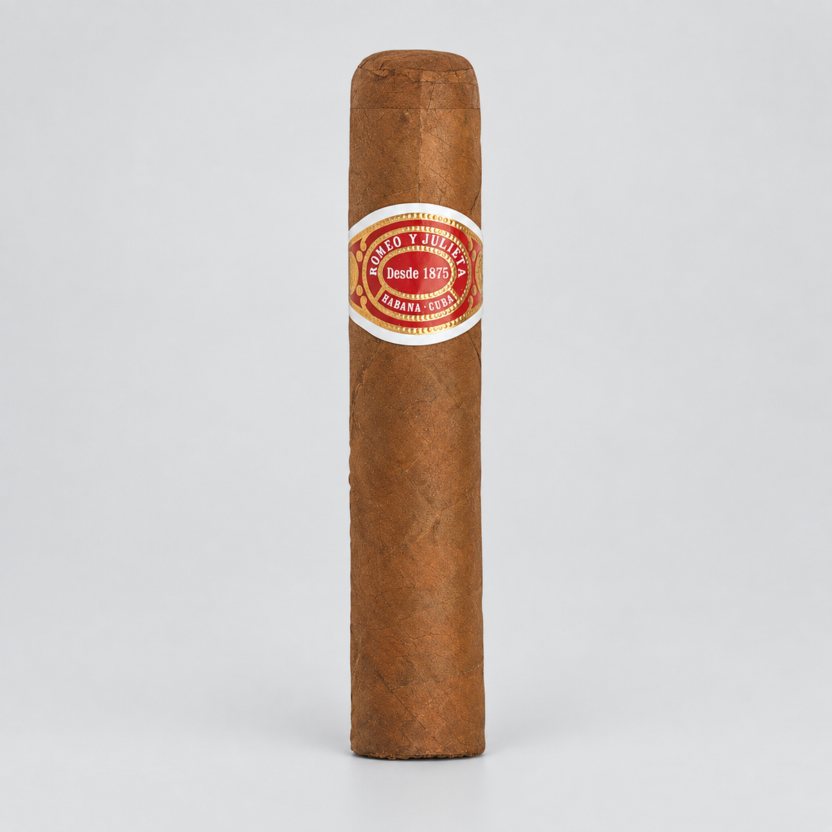 A single brown cigar standing upright on a light gray background, featuring a circular red and white band with the text 'Migado y Humedal Desde 1873'.