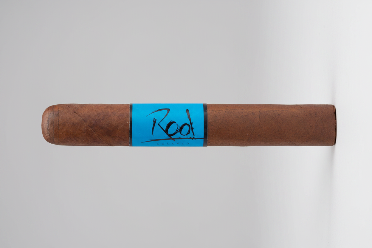 Cigar with blue band labeled 'Rook' on a white background