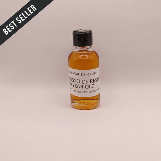 Small bottle of Russell's Reserve whiskey sample on a light gray background