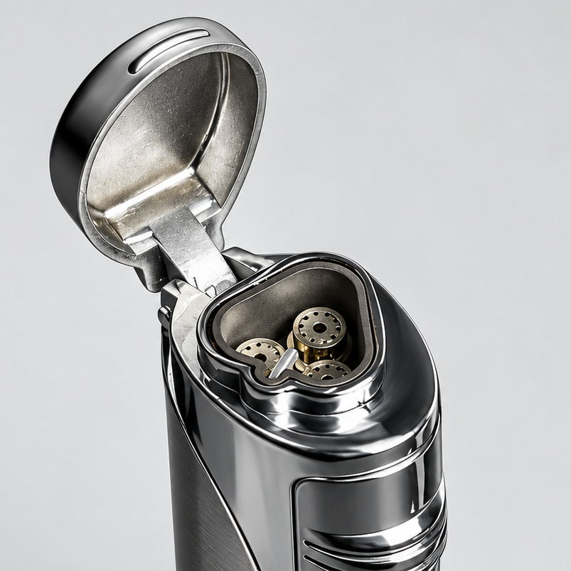A metallic silver lighter with its lid open, showing the internal ignition mechanism, set against a clean light gray background.