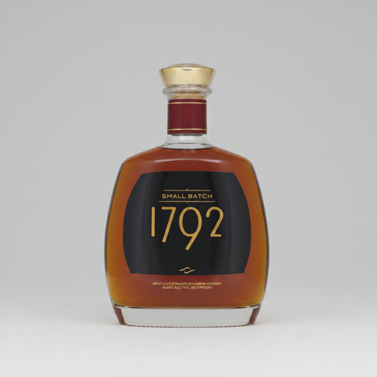 A bottle of 1792 Small Batch Kentucky Straight Bourbon Whiskey with amber liquid, a black label with gold lettering, and a gold cap, isolated on a white background.