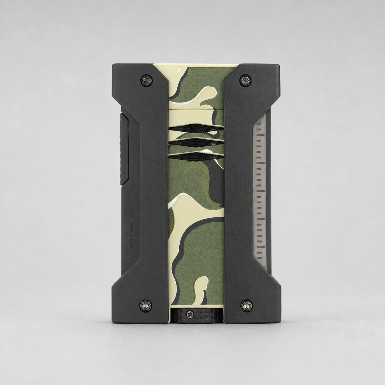 A rectangular ST DUPONT LIGHRTER with a black rugged frame and a central camouflage pattern panel in green, beige, and black, shown against a neutral gray background.