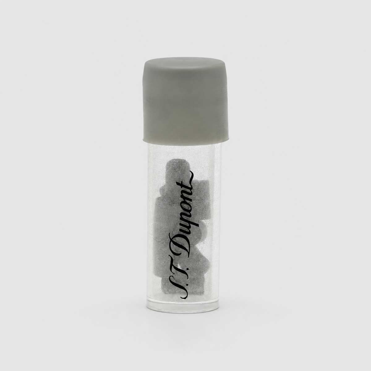 A small clear cylindrical vial with a gray screw cap, containing several dark gray irregular pieces, with the brand name 'N.F.