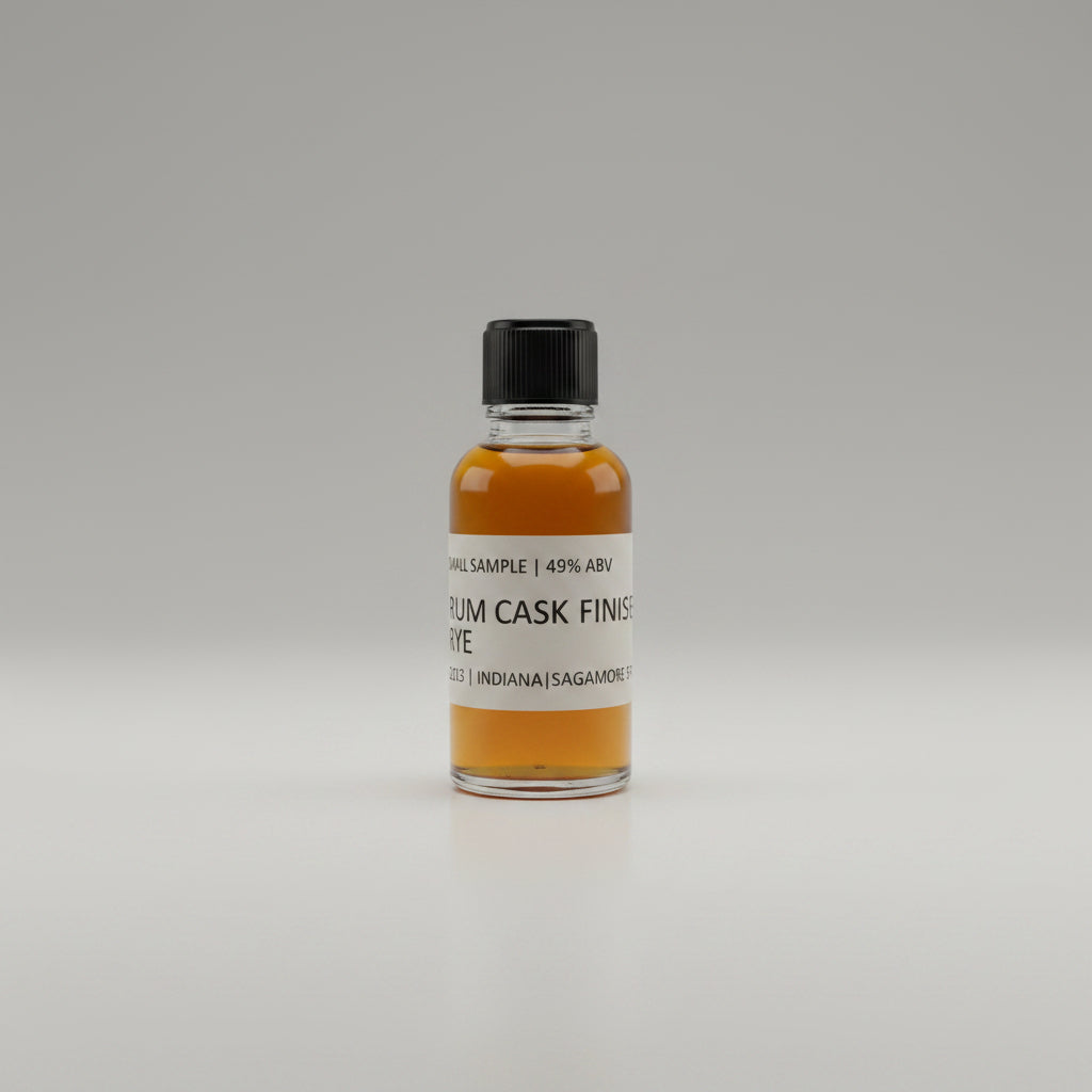 Small bottle of rum cask finished whiskey  on a white surface.