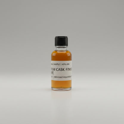 Small bottle of rum cask finished whiskey  on a white surface.