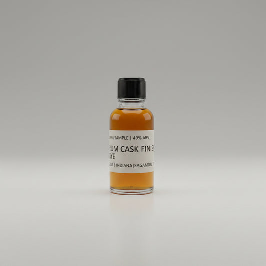 Small bottle of rum cask finished whiskey  on a white surface.