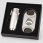 A silver metal cigar set including a lighter and a double-cutting cigar cutter, presented in a black gift box with a black foam insert.