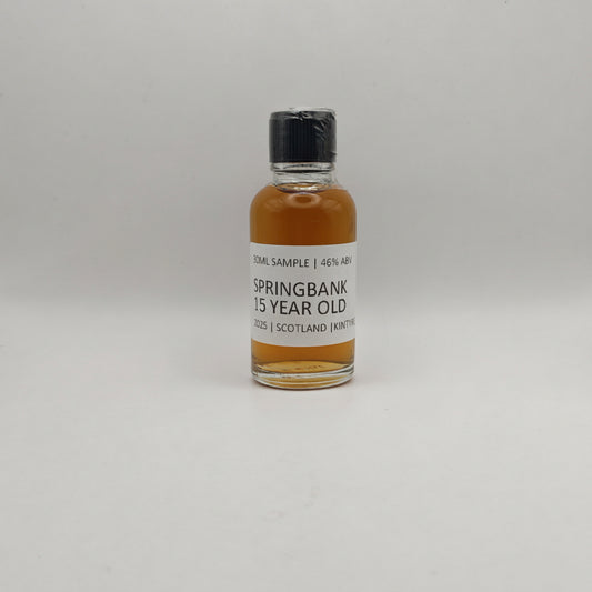 Small bottle of Springbank whisky sample on a gray background