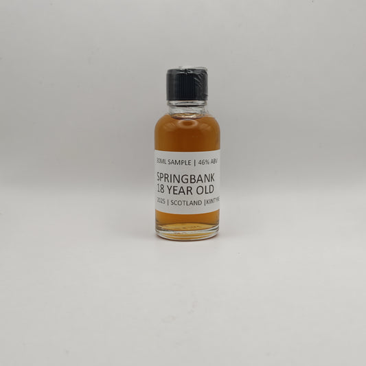 Small bottle of Springbank 18 year old whisky sample on a gray background