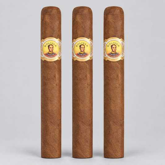 Three brown cigars standing upright side by side on a light gray background, each with a circular gold and white band featuring a portrait and the text 'Cigars El Granado'.