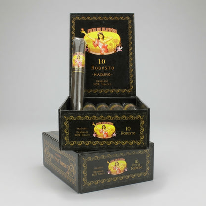 A stack of black and gold Mavila Robusto cigar boxes, with the top box open to display a single rolled cigar and several cigars inside, set against a neutral gray background.