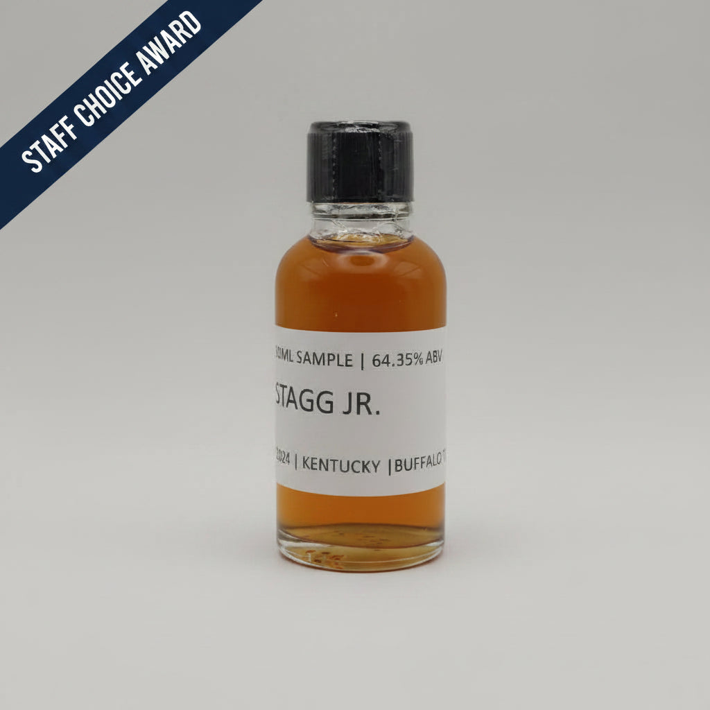 Small bottle of Stagg Jr. whiskey sample with a white label on a light gray background