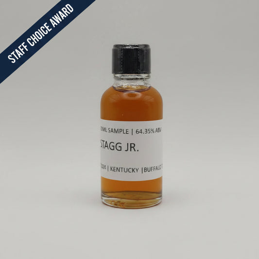 Small bottle of Stagg Jr. whiskey sample with a white label on a light gray background
