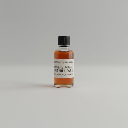 Small bottle of Maker's Mark bourbon on a white surface with a textured gray background