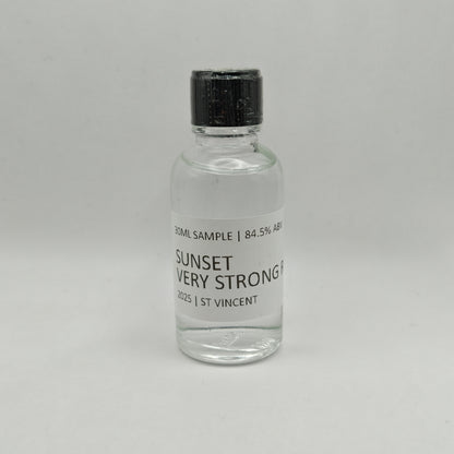 Small glass bottle of Sunset Very Strong Rum with a black cap on a gray background