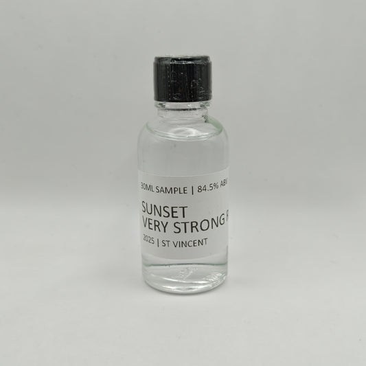 Small glass bottle of Sunset Very Strong Rum with a black cap on a gray background