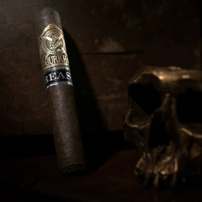 Cigar with a brand label next to a skull on a dark background