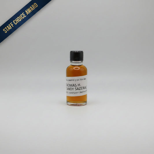 Small bottle of Thomas H. Handy Sazerac whiskey with a black cap on a light white background