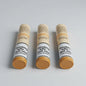 Three Corona Majors cigar tubes arranged in a row on a light gray background. Each tube has a beige cap and base, a white label with black text reading 'Smoking kills quit now', and a yellow-orange balm visible at the bottom.