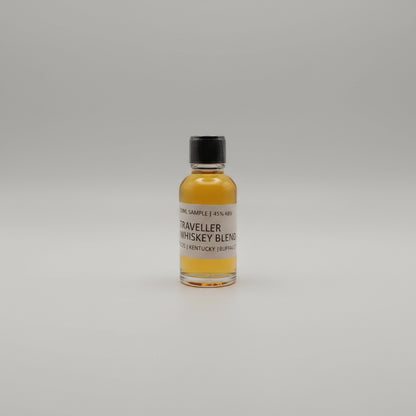 Small bottle of Traveller Whiskey Blend on a light gray background