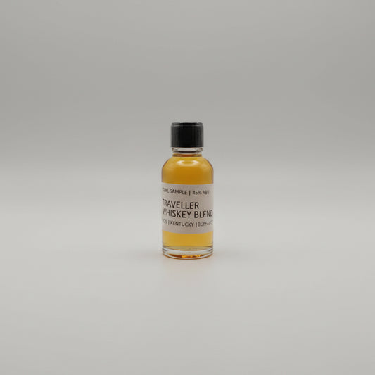 Small bottle of Traveller Whiskey Blend on a light gray background