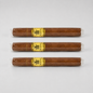 Three brown cigars in clear plastic wrapping with gold and black bands, arranged horizontally on a light gray background.