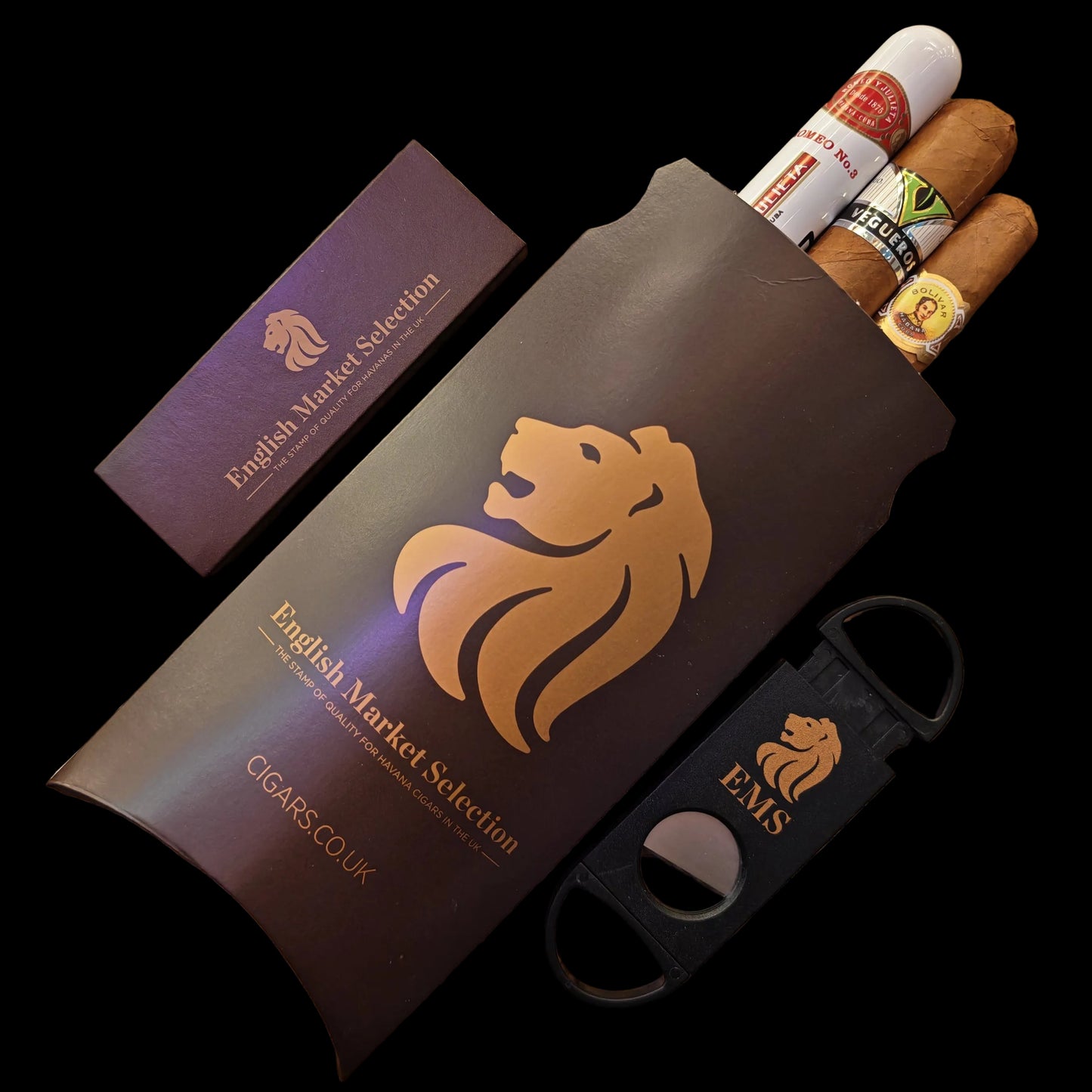 Cigar gift box with cigars, a cigar cutter, and a packet of cigar matches