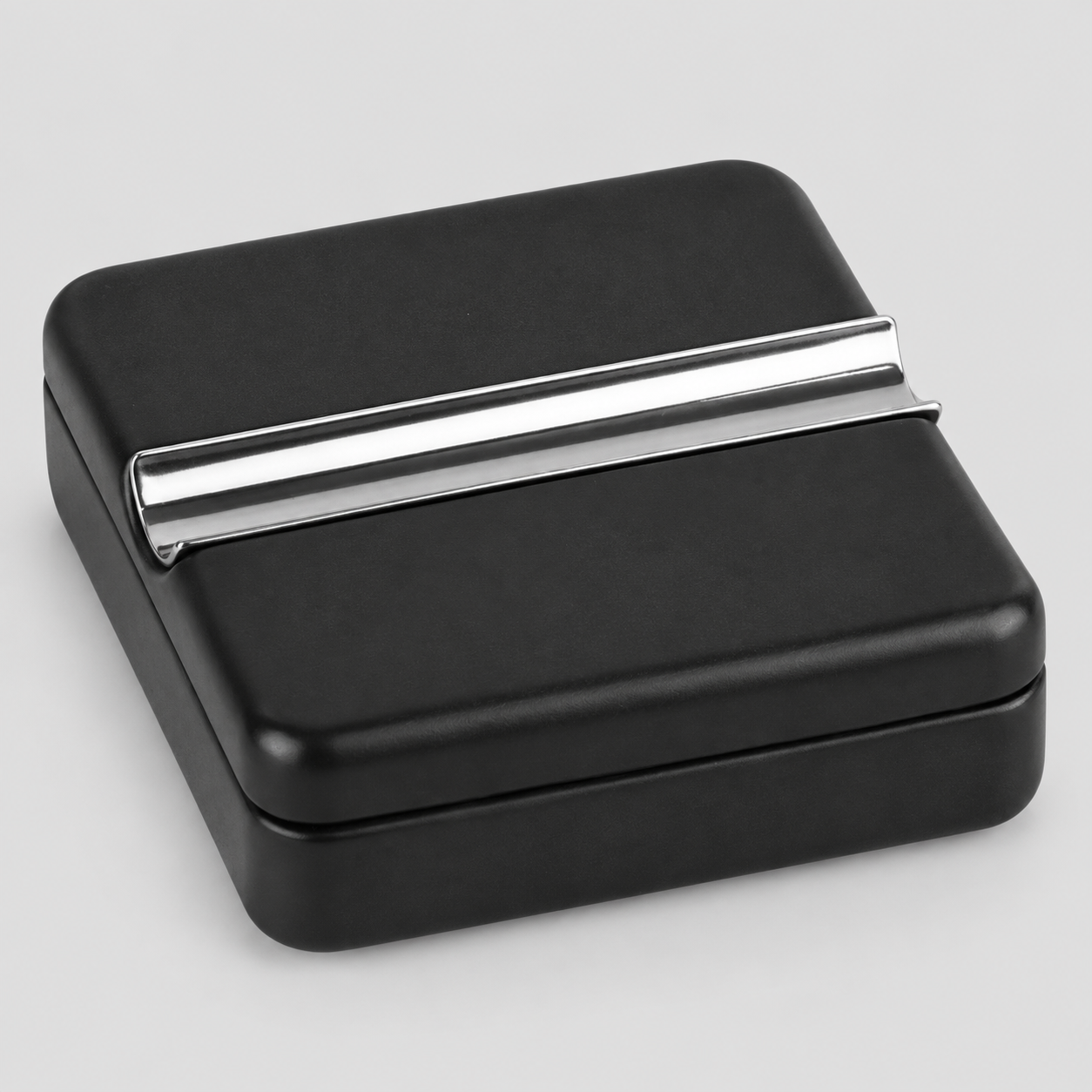 A square black CIGAR ASHTRAY box with a sleek, polished silver metallic CIGAR REST bar across the top, shown on a neutral light gray background.