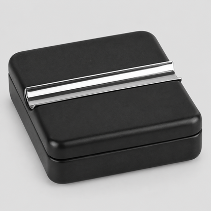 A square black CIGAR ASHTRAY box with a sleek, polished silver metallic CIGAR REST bar across the top, shown on a neutral light gray background.
