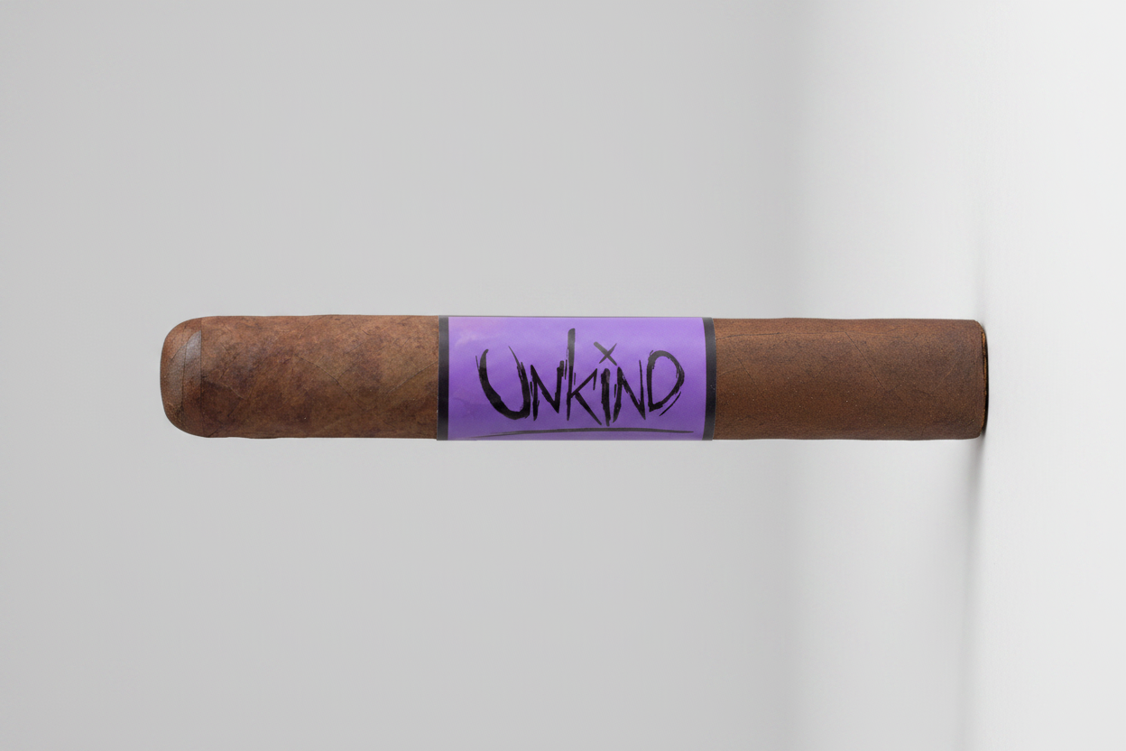 Cigar with 'Unkind' branding on a purple band