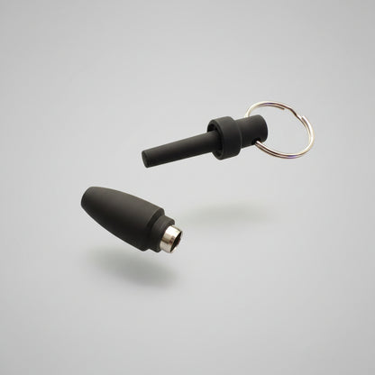 Two black silicone cigar punch cutters tips with metal connectors and a keyring, placed on a white background 