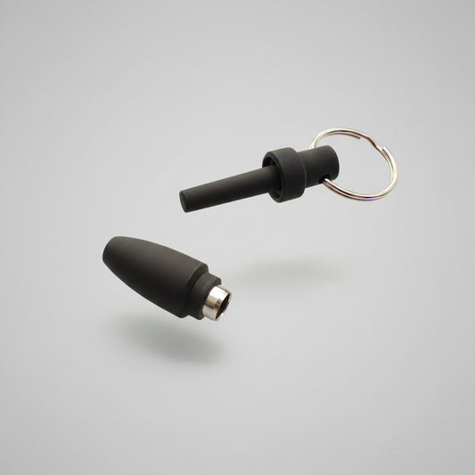 Two black silicone cigar punch cutters tips with metal connectors and a keyring, placed on a white background 