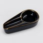 A glossy black ceramic ashtray with a gold-trimmed rim and gold dividing lines, shown on a light gray background.