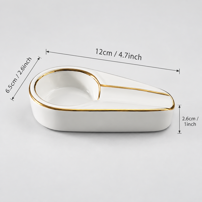 White ceramic double-compartment dish with gold trim, shown on a light gray background with dimension lines and text indicating measurements of 12cm by 6.5cm.