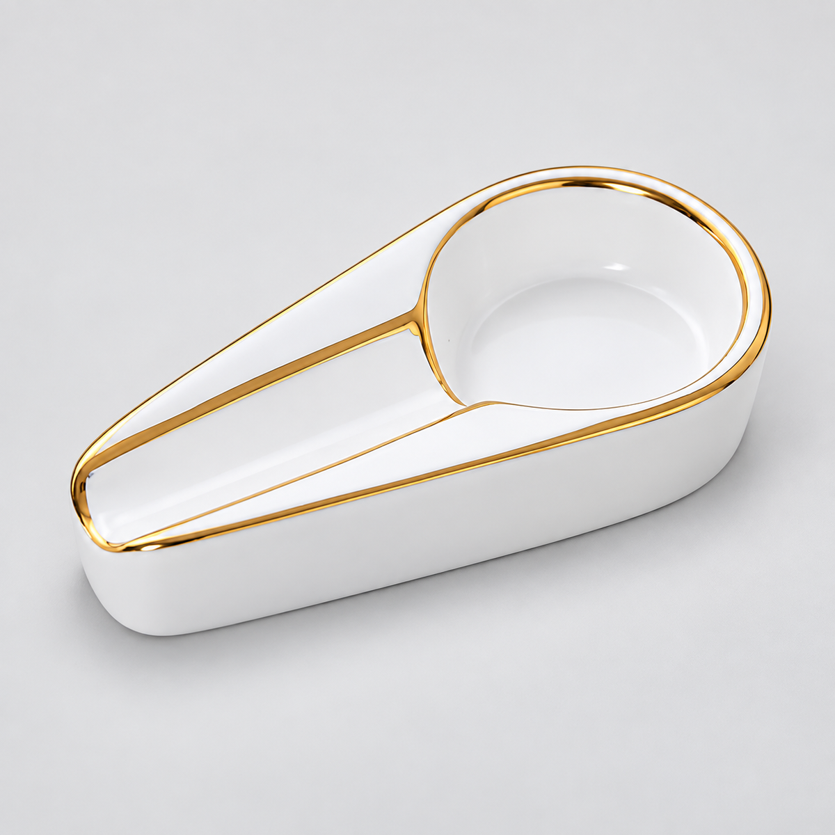 A white ceramic desk organizer tray with a gold-trimmed circular opening, photographed on a light gray background.