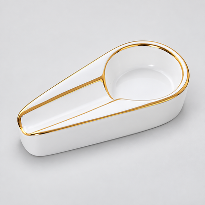 A white ceramic desk organizer tray with a gold-trimmed circular opening, photographed on a light gray background.