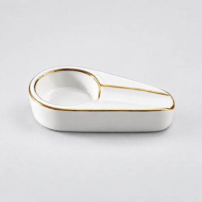 A white ceramic desk organizer tray with a gold-trimmed edge and a built-in pen loop, photographed on a clean light gray background.