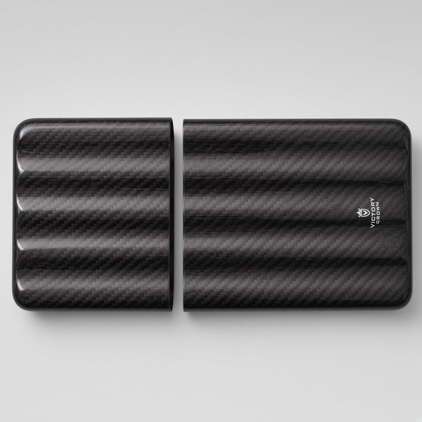 A black carbon fiber patterned portable power bank shown in two halves on a light gray background, with a small white logo on the right half.