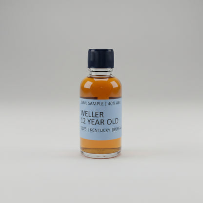 Bottle of Weller 12 Year Old Kentucky Bourbon on a bar counter with blurred bottles in the background.