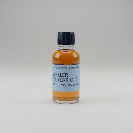 Bottle of Weller 12 Year Old Kentucky Bourbon on a bar counter with blurred bottles in the background.
