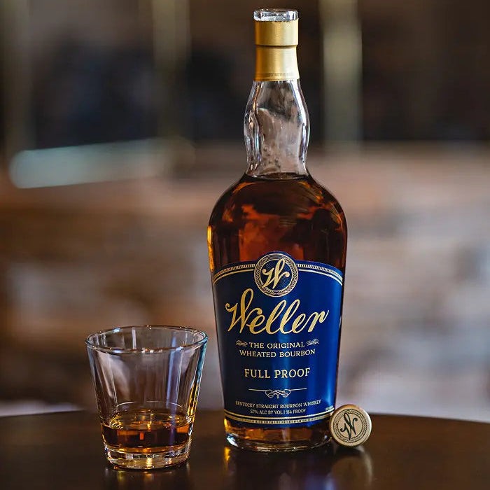 Weller Full Proof bourbon bottle with a glass on a wooden surface