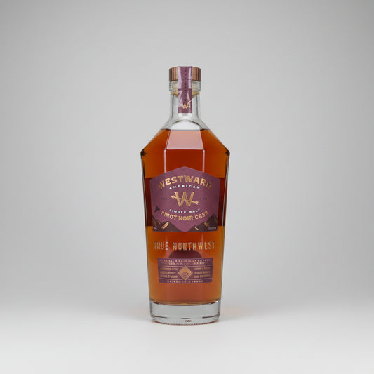 A bottle of Westward American Full Northwest AMERICAN Whisky, showing the amber liquid and maroon label against a white background.