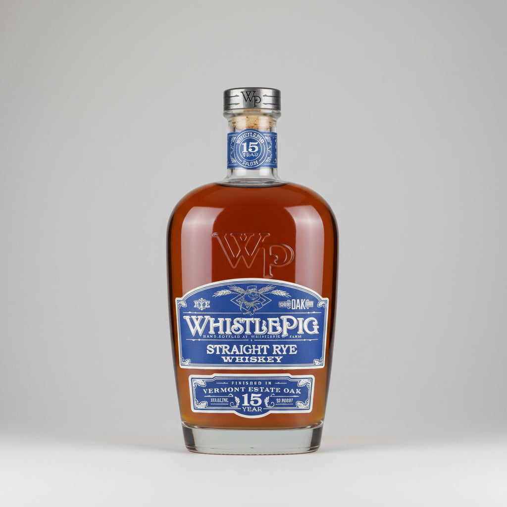 A bottle of Whistlepig Straight Rye Whiskey in a 15-year Vermont Estate Oak style, featuring amber liquid, a blue and white label, and a silver cap on a white background.