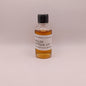 Small bottle of Weller Antique 107 whiskey sample on a light gray background