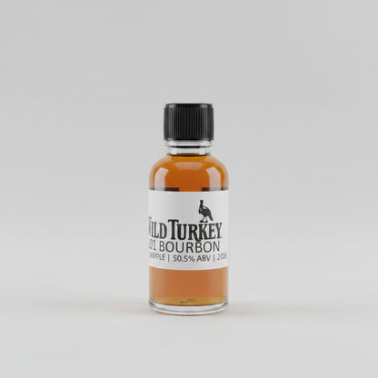 Small bottle of Wild Turkey bourbon on a bar counter with a blurred bar background