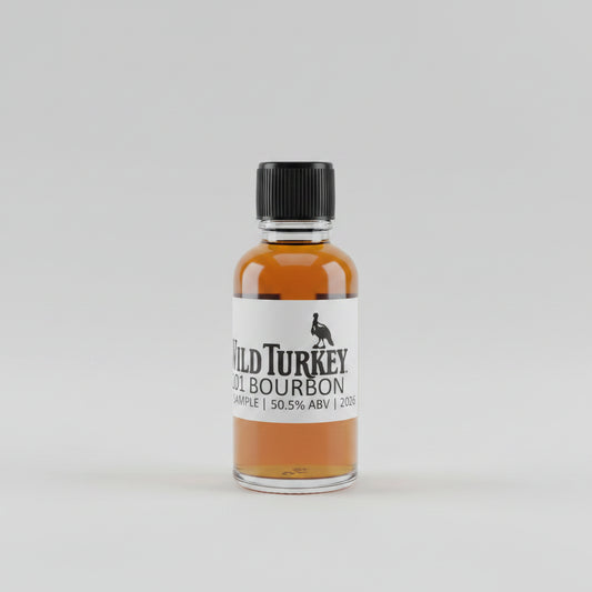 Small bottle of Wild Turkey bourbon on a bar counter with a blurred bar background