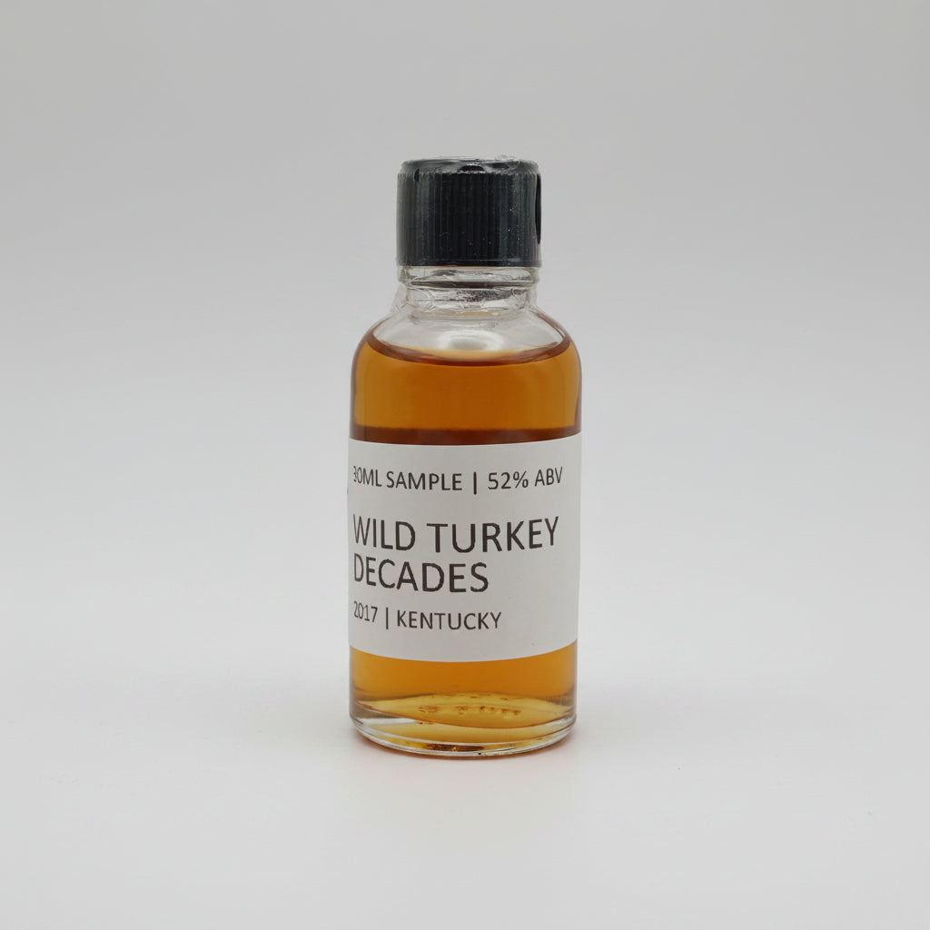 Small bottle of Wild Turkey Decades whiskey on a white background